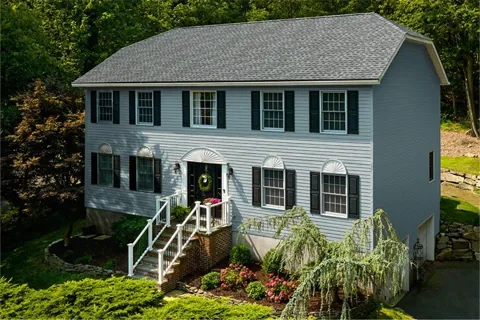 GAF manufacturer example: light blue house with Timberline HDZ in Pewter Gray